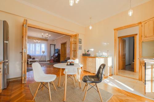 a kitchen and dining room with a table and chairs at Old town Boheme Apartment in Timişoara