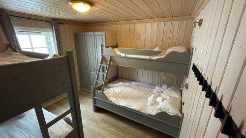 a room with two bunk beds in a cabin at Tinden in Hemsedal