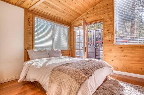 a bedroom with a bed in a room with wooden walls at 019 - Almost Heaven in Big Bear Lake