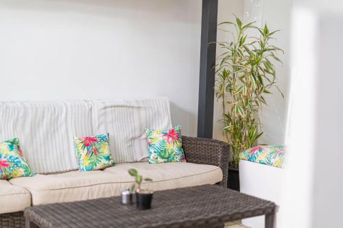 a living room with a couch and a table with pillows at Hotel Las Colinas in Fortuna