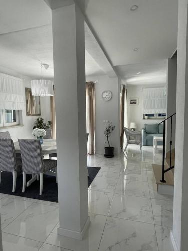 a living room and dining room with a table and chairs at Island Brac - Villa Vita in Nerežišće