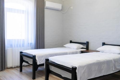 Una cama o camas en una habitación de NEST INN