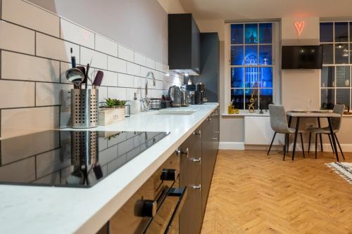 a kitchen with a white counter top and a table at Abbey View studio central Bath in Bath