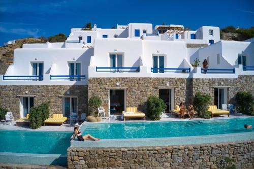 a hotel with a swimming pool in front of a building at San Antonio Summerland in Mýkonos City