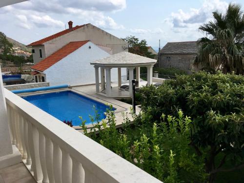 a balcony with a swimming pool and a gazebo at Apartments Villa Jadranka Adults only in Bol