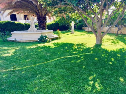 a statue sitting in the middle of a grass field at Apartments Villa Jadranka Adults only in Bol