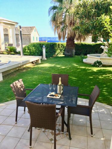 a blue table and chairs on a patio at Apartments Villa Jadranka Adults only in Bol