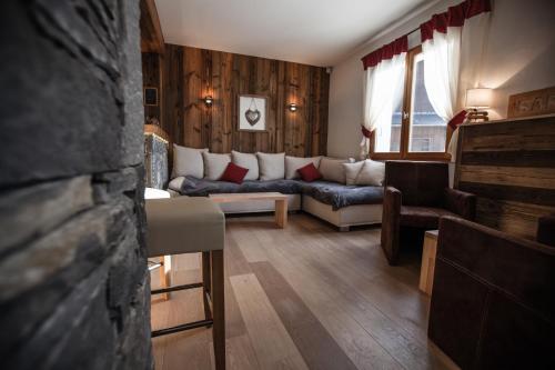 a living room with a couch and a table at Hotel Le Grand Tetras in Morzine