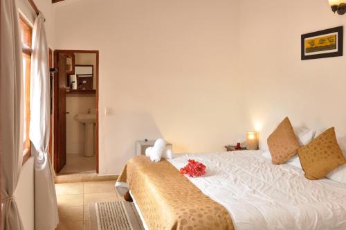 a bedroom with a bed with flowers on it at Casa de Campo Hotel & Spa in Villa de Leyva