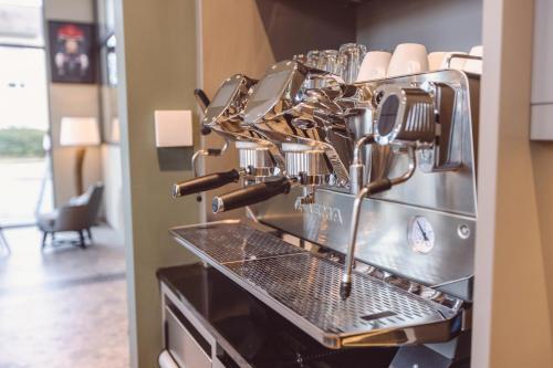 a kitchen with a coffee making machine at Hotel Libertas elements pure in Freiburg im Breisgau