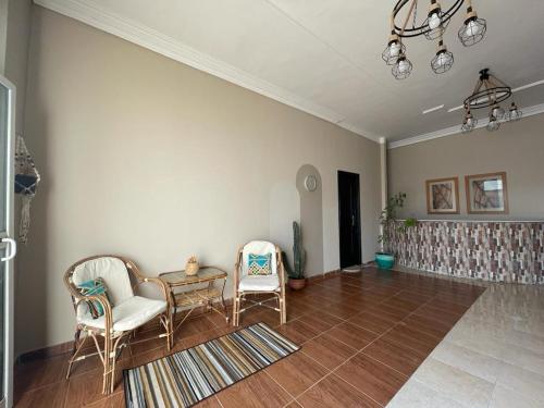 a living room with two chairs and a table at La Casa Guest House in Marsa Alam City