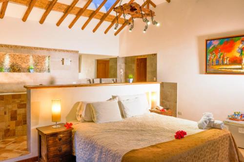 a bedroom with a large bed in a room at Casa de Campo Hotel & Spa in Villa de Leyva