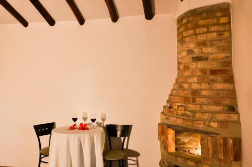 a table with two glasses of wine on it at Casa de Campo Hotel & Spa in Villa de Leyva