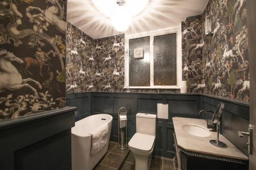 a bathroom with a toilet and a sink at The Angel of Bow in London