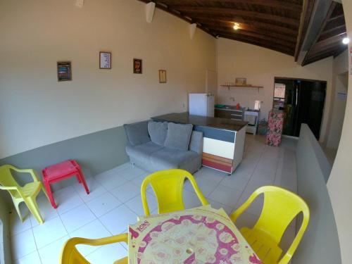 a living room with colorful chairs and a couch at Complexo Desenferruja uma quadra Praia da Ferrugem in Garopaba