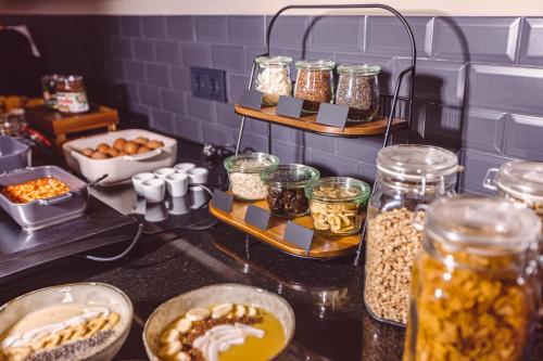 a kitchen counter with jars of food and other foods at Hotel Libertas elements pure in Freiburg im Breisgau