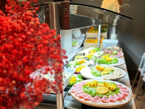 a buffet line with plates of food on display at Edition Old City Hotel in Istanbul