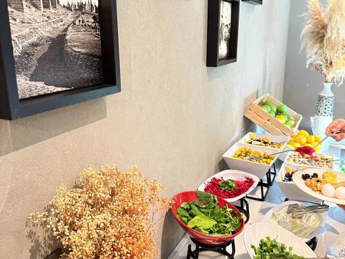 a table topped with bowls of vegetables and fruits at Edition Old City Hotel in Istanbul