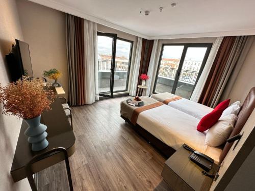 a bedroom with a large bed and a large window at Edition Old City Hotel in Istanbul