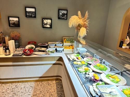 a buffet line with plates of food on display at Edition Old City Hotel in Istanbul