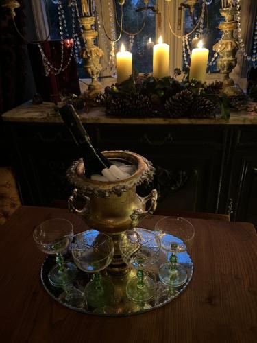 a table with candles and glasses and a candlesticks at Pytts House Boutique Bed & Breakfast in Burford
