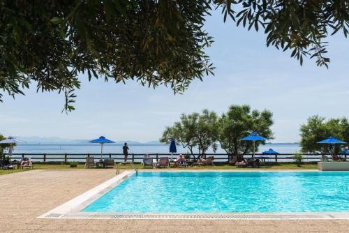 a swimming pool with a view of the ocean at Villa Aliki in Barbati