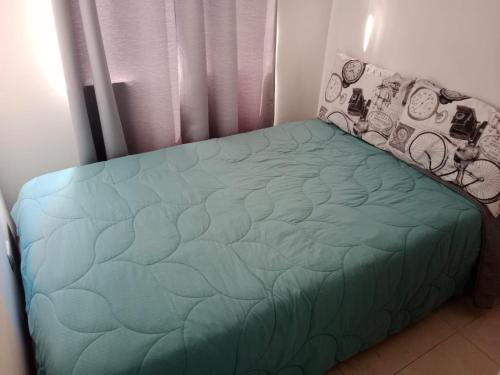 亞美尼亞的住宿－Apartamento vacacional amoblado，卧室内的一张床位,配有绿色的床罩