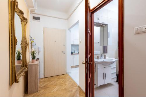 a bathroom with a mirror and a sink at Budapest Deluxe Apartman with free parking place in Budapest
