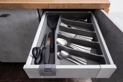 a drawer with silver utensils in a kitchen counter at Peaceful 1-bedroom apartment in 100m from Beach, Free Street Parking, Near Forest Park in Jūrmala