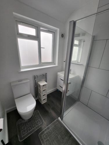 a bathroom with a toilet and a shower at Guest rooms in London