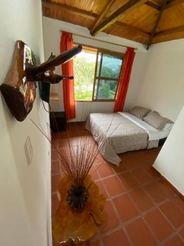 a room with a bed and a view of a room at CABAÑA LOS NOGALES in San Agustín