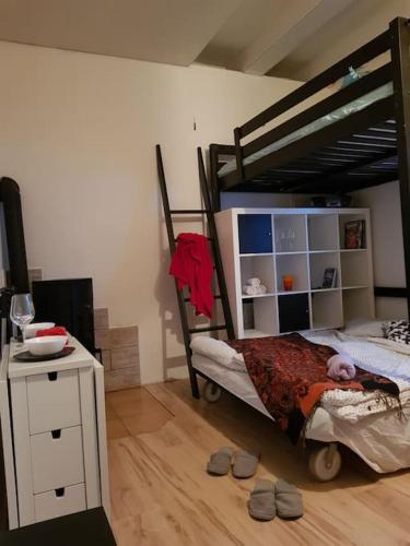 a bedroom with a bunk bed and a table with slippers at Základna - Minibyt Zdíkov in Zdíkov