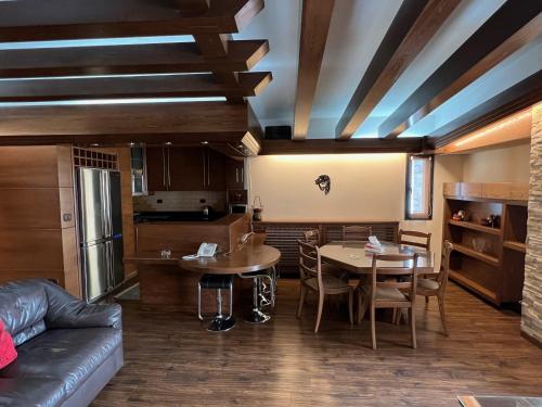 a living room with a couch and a table at Saint Michel Chalets in Al Arz