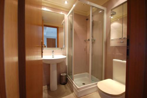 a bathroom with a shower and a sink and a toilet at Lets Holidays Apartment Sea Views in Barcelona in Barcelona