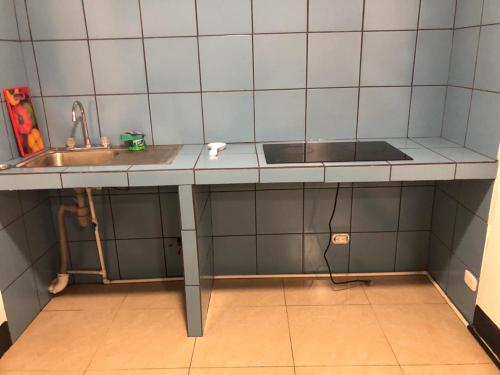 a kitchen with a sink and a counter top at Apartments Pura Vida in Alajuela City