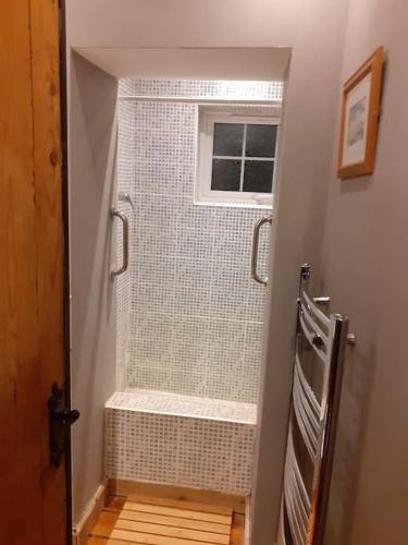 a bathroom with a walk in shower next to a window at Characterful Cottage near the Sea, Beach, Pier & Shops in Weston-super-Mare