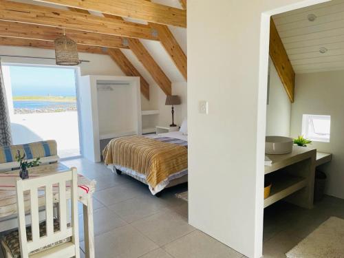 a bedroom with a bed and a view of the ocean at CVista in Jacobs Bay