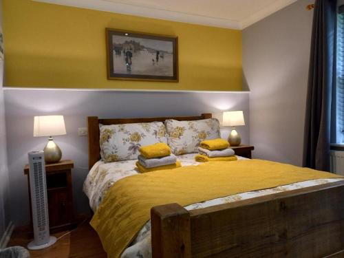 a bedroom with a bed with two pillows on it at Donkey & buskins in Layer de la Haye