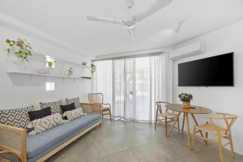 a living room with a couch and a table at Beach Club Delight in Mooloolaba
