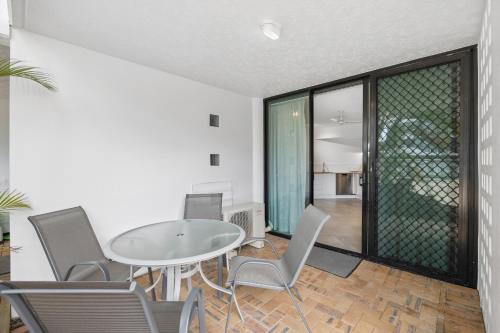 a dining room with a table and chairs at Beach Club Delight in Mooloolaba