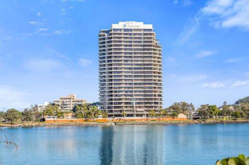 a tall building next to a large body of water at Bay View in Tweed Heads