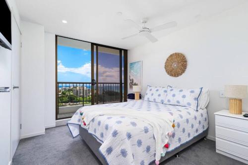 a bedroom with a bed and a large window at Bay View in Tweed Heads