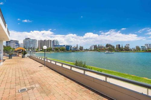 a walkway next to a river in a city at Bay View in Tweed Heads