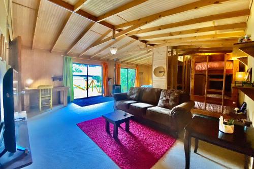 a living room filled with furniture and a large window at MaPatagonia Hostel in Puerto Varas