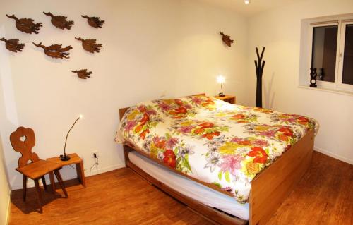 a bedroom with a bed with a floral comforter at Dolomit in Saas-Fee