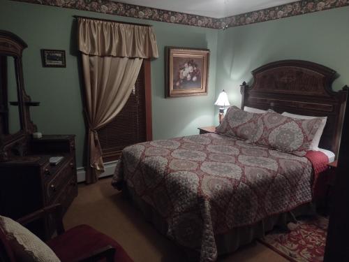 a bedroom with a large bed and a window at The Historic Elk Mountain Hotel in Elk Mountain