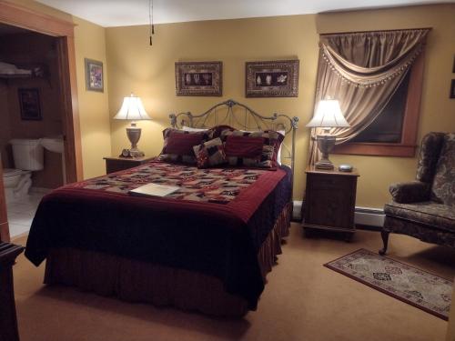 a bedroom with a bed and a chair at The Historic Elk Mountain Hotel in Elk Mountain