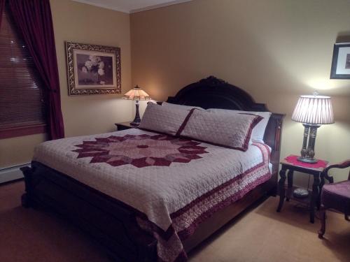 a bedroom with a bed with a quilt on it at The Historic Elk Mountain Hotel in Elk Mountain