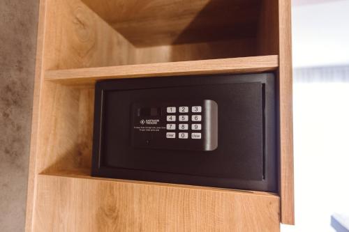 a microwave oven sitting inside of a wooden cabinet at Hotel Libertas elements pure in Freiburg im Breisgau