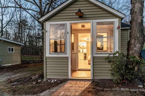 a small house with a door on the side of it at Cozy Cabin in a rural setting in Temple,NH -12 in Temple
